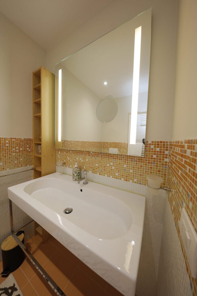 Lavabo e specchio a led del bagno, appartamento Cozy, Siena UpTown